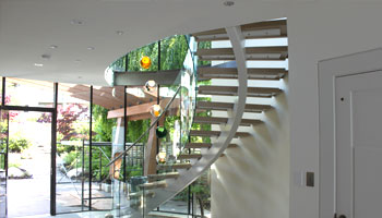 sleek mondern staircass with glass railings