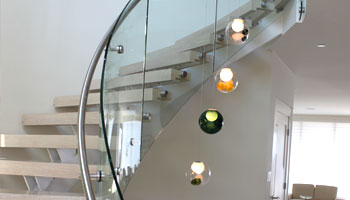 curving glass railings on interior staircase